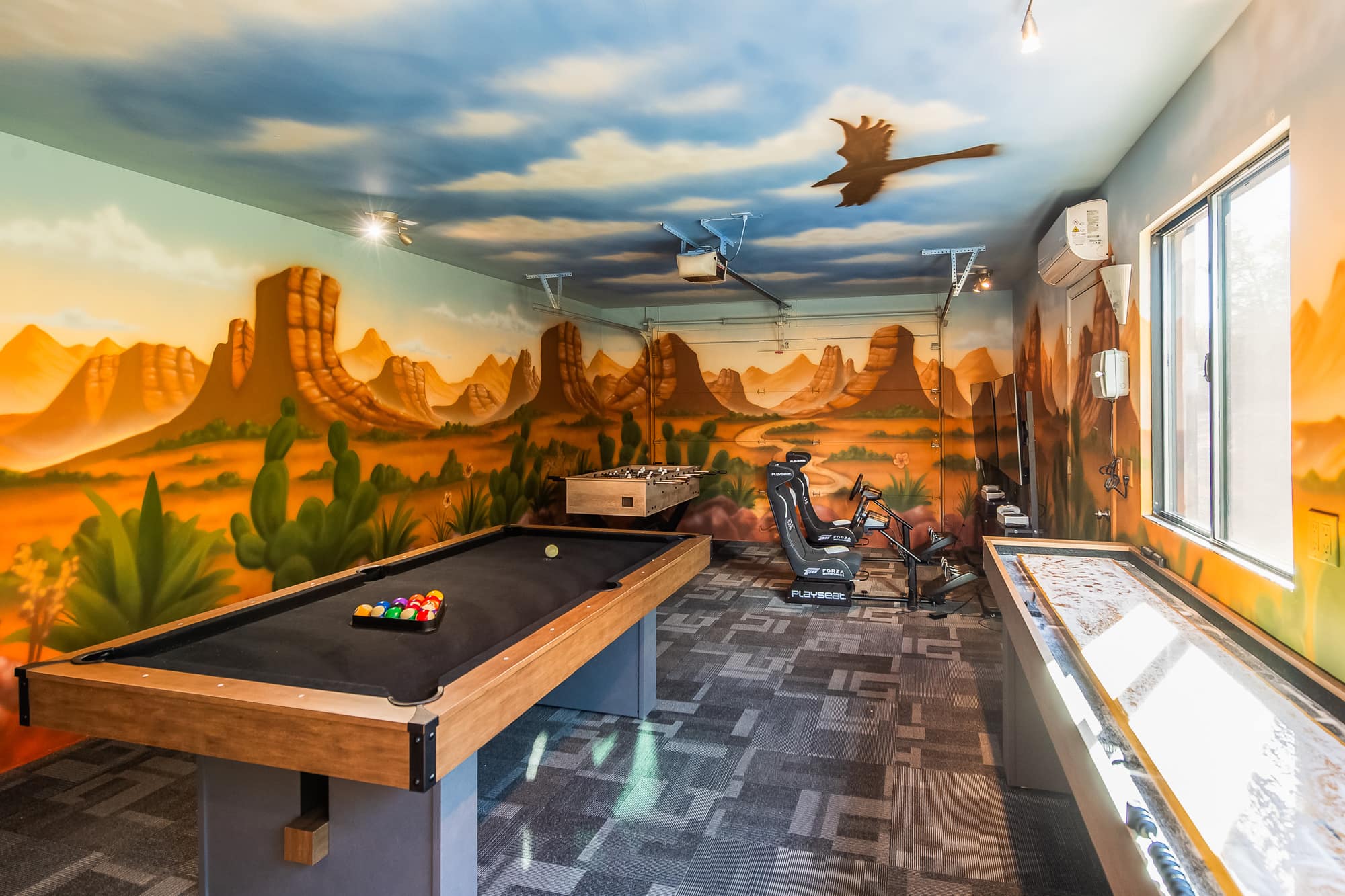 The pool table in the desert-mural game room