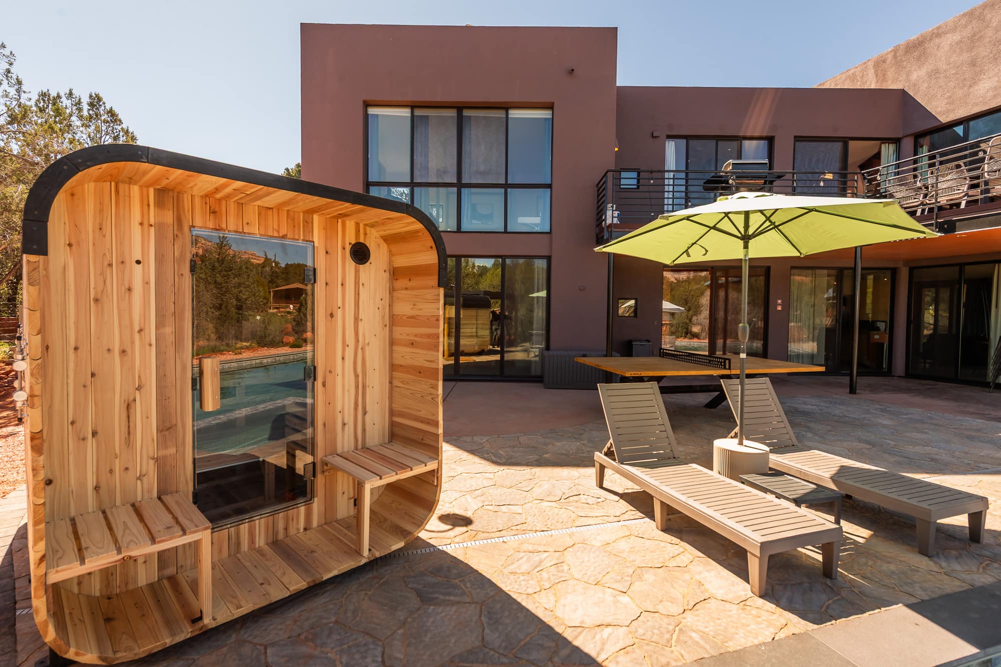 The cedar outdoor sauna on the pool patio